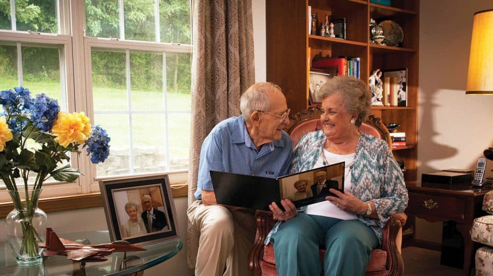 Senior couple looking at a picture book